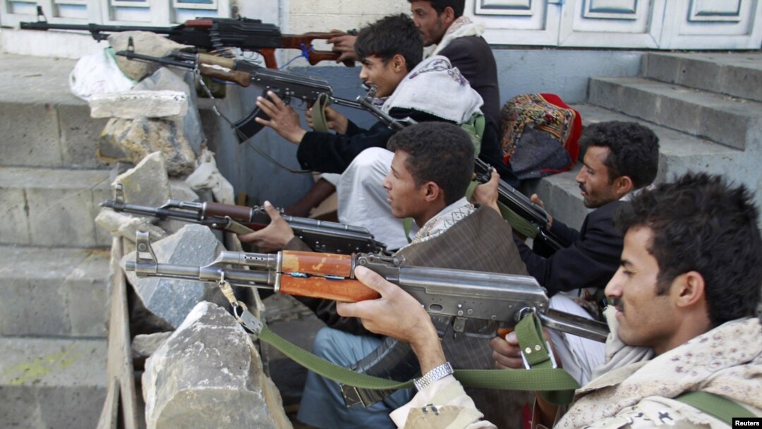 Yemeni tribesmen take positions on a street near the house of tribal leader Shiekh Sadiq al-Ahmar during clashes with police in Sanaa on May 24.