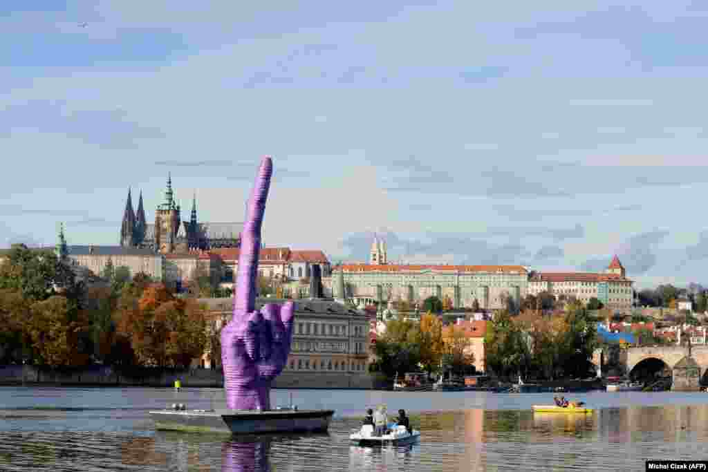 The giant purple "middle finger" sculpture by Czech artist David Cerny on October 21, 2013 in Prague's Vltava River. It was installed four days before the early Czech general elections and targets the state of Czech politics and the "endemic corruption" of Czech President Milos Zeman, said Cerny.