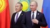 Russian President Vladimir Putin (right) could be looking for inspiration in the way his old Kazakh counterpart, Nursultan Nazarbaev, has stepped down but is still keeping his irons in the fire.