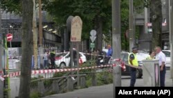 Dutch police officers stand near the scene of a stabbing attack near the central daily station in Amsterdam, on August 31.