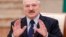 Belarusian President Alyaksandr Lukashenka reacts during a meeting with the media in Minsk on December 14. 