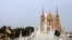 The flags of Vatican City (left) and Pakistan fly at half mast ahead of the funeral ceremony of the German-born nun Ruth Pfau, at the premises of the St. Patrick's Cathedral in Karachi on August 18.