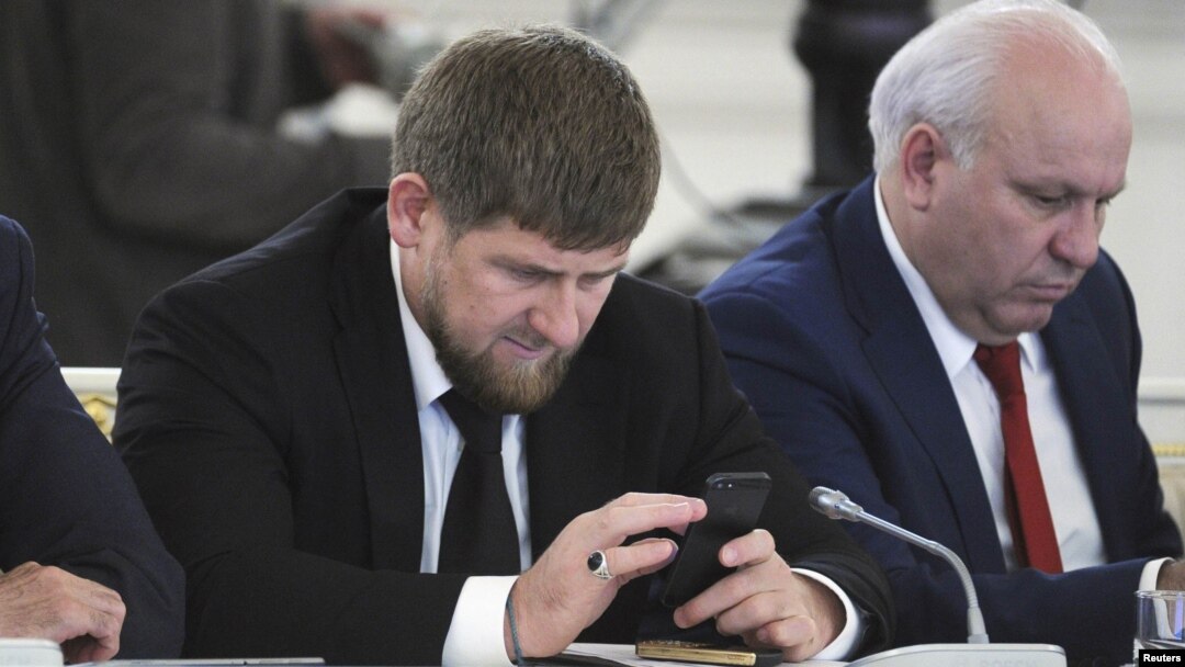 Chechen leader Ramzan Kadyrov (left) seems very attached to his cell phone and is an active Instagram user. (file photo)