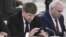 Chechen leader Ramzan Kadyrov (left) seems very attached to his cell phone and is an active Instagram user. (file photo)