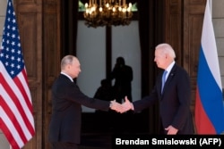 Vladimir Putin shakes hands with U.S. President Joe Biden prior to a summit in Geneva on June 16.