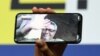 Director Mohammad Rasoulof, winner of the Golden Bear in Berlin for There Is No Evil, speaks through a video call as his daughter Baran Rasoulof holds up a smartphone during a news conference on February 29 after the awards ceremony.