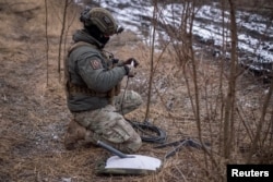 A Ukrainian soldier prepares a Starlink satellite Internet system at a frontline position in the town of Avdiyivka in February 2024.