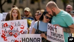 Relatives of Azov Regiment soldiers rallied in Kyiv on July 30. Many have worried that the court's designation could mean those who surrendered to Russia, or were captured by Russian forces, could be tried as terrorists. 