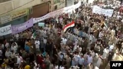 An image grab taken from a video uploaded on YouTube on October 7 shows people demonstrating in the central city of Hama.