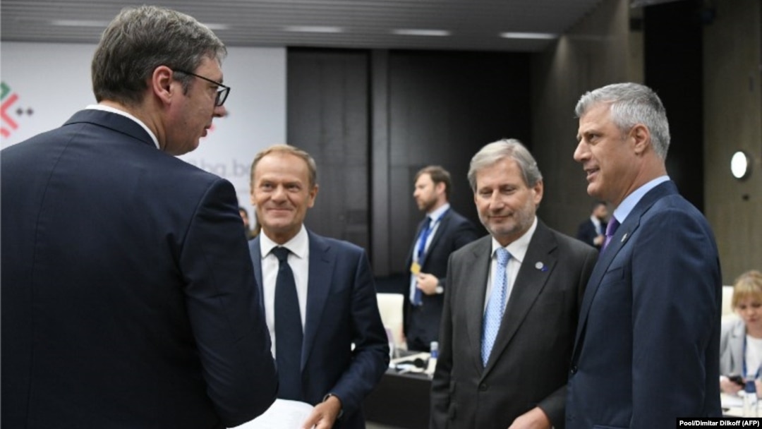Serbian President Aleksander Vucic (left) speaks with Kosovar President Hashim Thaci (right) next to European Commissioner for European Neighborhood Policy Johannes Hahn (2nd right) and European Council President Donald Tusk during the EU-Western Balkans summit last month.
