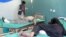 Afghan men receive treatment at a hospital after suicide bombers and gunmen attacked a provincial Afghan police headquarters in Gardez on October 17.