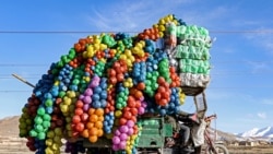 <p>An Afghan vendor carries plastic containers on a three-wheeler rickshaw in Maidan Wardak Province. 