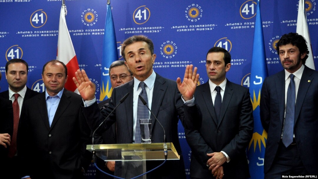 Bidzina Ivanishvili (center) is seen presenting his cabinet picks in Tbilisi on October 8. A relative newcomer to politics, analysts suggest Ivanishvili must still tame the nine parties composing his Georgian Dream coalition.