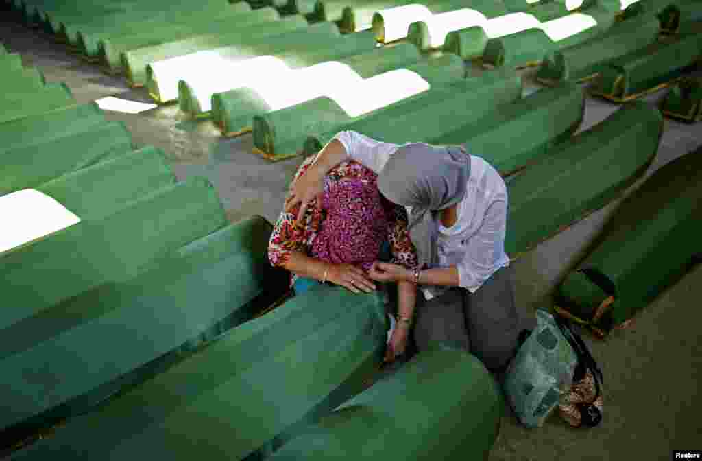 Bosnian women cry near one of the 173 coffins of newly identified victims from the 1995 Srebrenica massacre, in the Potocari Memorial Center, near Srebrenica, Bosnia-Herzegovina, ahead of the 19th anniversary of the massacre. (Reuters/Dado Ruvic)