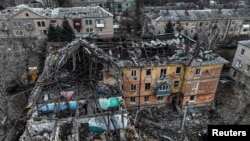 An aerial view shows a residential building heavily damaged by a Russian missile strike in the town of Selydove on February 8.