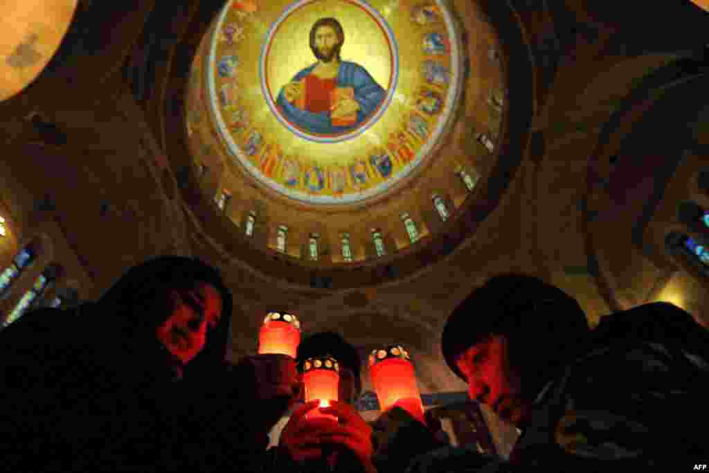 Children hold candles in Saint Mkrtich (Saint John) church in the Armenian city of Abovyan during the Armenian Orthodox Christmas eve. (AFP/Karen Minasyan)