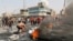 A demonstrator burns tires during a curfew, two days after the nationwide anti-government protests turned violent, in Baghdad, October 3, 2019