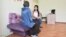 Evacuated from Syria, a resident of Aqtobe, Kazakhstan, talks with a psychologist in a rehabilitation center. (file photo)