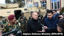 Acting U.S. Defense Secretary Patrick Shanahan (second from right) and acting Afghan Defense Minister Asadullah Khalid (right) visit an Afghan special force unit on the outskirt of Kabul on February 11.