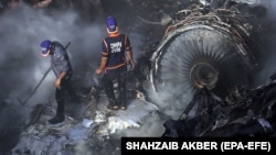 Rescue workers search for survivors amid the wreckage of a passenger plane, which crashed in Karachi on May 22.