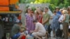 Residents wait in line to collect water delivered by a tank truck in the course of Russia-Ukraine military conflict, in Donetsk, a Russian-controlled city of Ukraine.