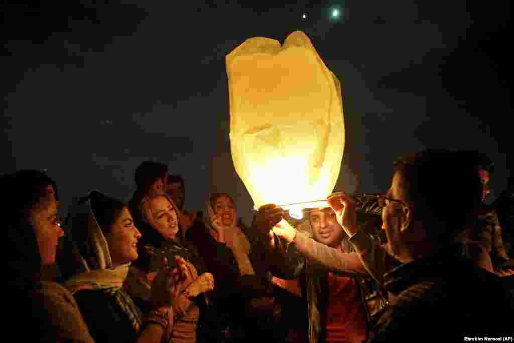 Iranians release a lit lantern during a celebration, known as &quot;Chaharshanbe Souri,&quot; or Wednesday Feast, Tuesday, March 19, 2019, marking the eve of the last Wednesday of the solar Persian year, in Tehran, Iran.