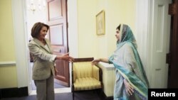 Malala Yousafzai walks to shake hands with U.S. House Minority leader Nancy Pelosi (D-CA) during a visit at Capitol Hill in Washington on June 23.