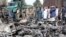 Afghan security officials inspect the scene of a bomb blast outside the Great Mosque in Herat on June 6.