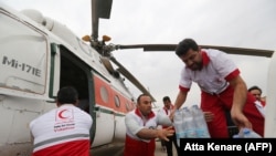 Iranian Red Crescent volunteers receive aid to be distributed to people in Ahvaz, the capital of the southwestern Iranian province of Khuzestan, on April 9. 