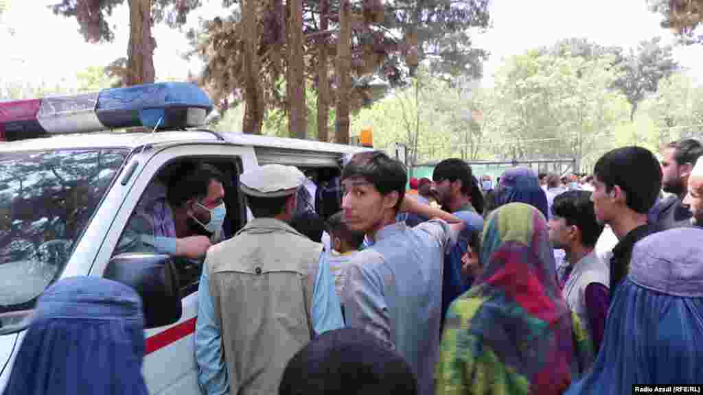 People seeking medical care gather around an ambulance in Kabul&#39;s northern Khair Khana district on August 11.