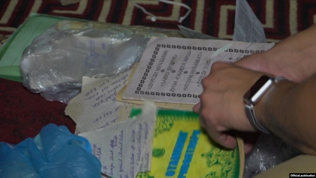 In an undated photo provided by Uzbekistan's Interior Ministry, police raid the home of an alleged religious-extremism suspect.