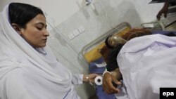 A Pakistani security official receives treatment at a hospital in Peshawar after he was injured in a bomb blast on April 24.