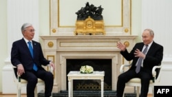 Russian President Vladimir Putin speaks with Qasym-Zhomart Toqaev during their meeting at the Kremlin in Moscow on November 11.