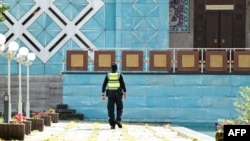 A police officer is seen in front of the Blue Mosque, housing the Islamic Center of Hamburg, in Germany on July 24.