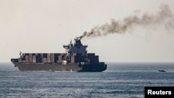 U.S forces patrol near the Iranian-flagged cargo ship M/V Touska after it was boarded and seized by US forces on April 19 in the Gulf of Oman.