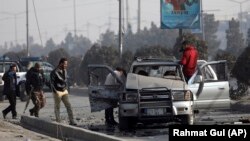 Security personnel inspect the site of a bomb attack in Kabul on February 2.