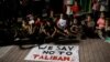 Children sit in front of a banner reading "We say no to Taliban" as Afghan migrants demonstrate against the Taliban takeover of Afghanistan on the island of Lesbos, Greece, on August 16.