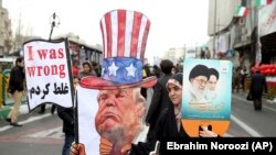 An Iranian woman holds an effigy of U.S. president Donald Trump, during a rally marking the 40th anniversary of the 1979 Islamic Revolution, in Tehran, February 11, 2019