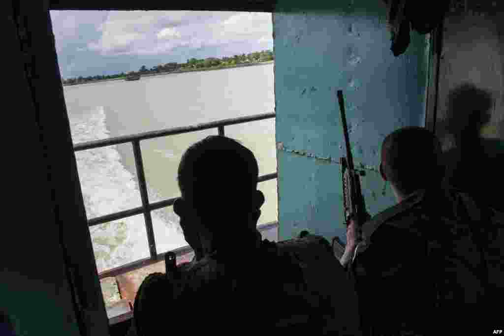 Burmese soldiers travel by boat from Buthidaung to Sittwe in Rakhine State.