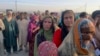 Afghan families gather to receive food distributed by an Islamabad-based Christian organization on the outskirts of Chaman, a border town in Pakistan&#39;s southwestern Balochistan Province, on August 31.