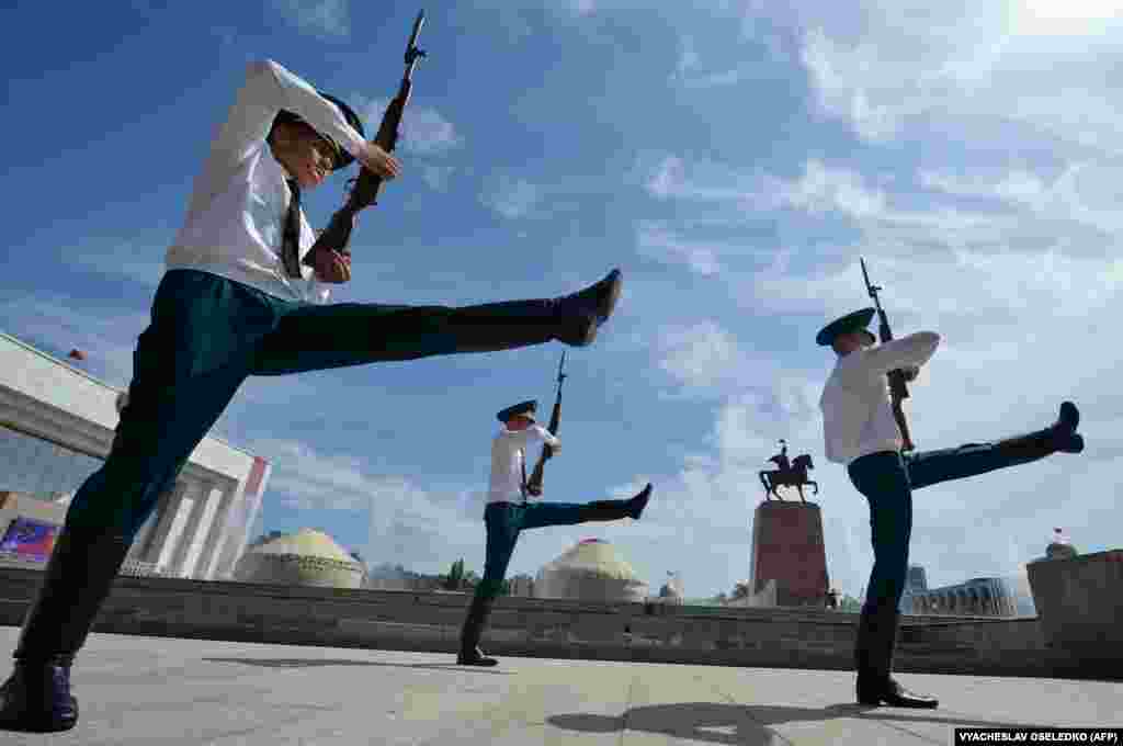 Kyrgyz honor guards march during the changing of the guards ceremony on Ala-Too Square in Bishkek.