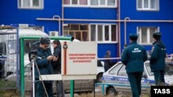 Russian police examine outside a court building in the western Siberian city of Kurgan where three grenades were detonated on November 1.