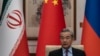 China's Foreign Minister Wang Yi speaks during a meeting with his Russian and Iranian counterparts in March 2025. 