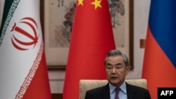 China's Foreign Minister Wang Yi speaks during a meeting with his Russian and Iranian counterparts in March 2025. 