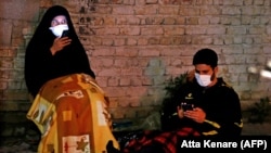 Iranians wearing face masks attend prayers during the Muslim fasting month of Ramadan in Tehran earlier this month.