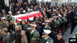 The honor guard carry the coffin of Iran's former ambassador to Lebanon Ghazanfar Roknabadi, who was killed in Saudi Arabia, during a repatriation ceremony upon the arrival of his body at Tehran's Mehrabad Airport on November 27, 2015. 