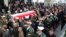 An Iranian honor guard carries the coffin of a former ambassador to Lebanon, Ghazanfar Roknabadi, who was killed during the hajj in Saudi Arabia in a repatriation ceremony upon the arrival of his body at Tehran's Mehrabad Airport on November 27, 2015. 