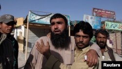 Relatives of police cadets wait for word outside the Police Training Center after an attack on the center in Quetta, October 25, 2016