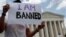 Mehrad Ansari of Iran holds a sign outside of the U.S. Supreme Court on June 26, 2018.