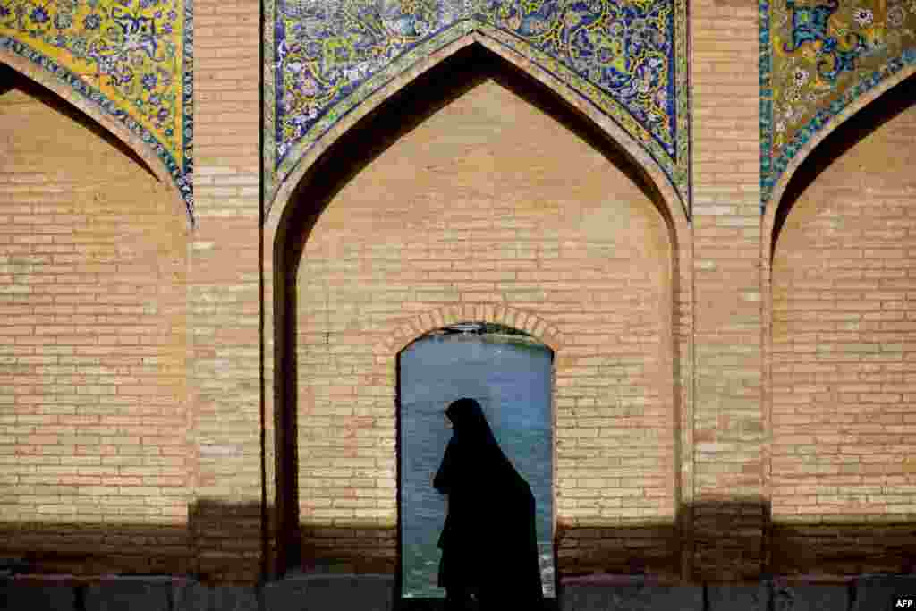 An Iranian woman walks on the Khajou Bridge in the historic city of Isfahan on April 21.&nbsp;